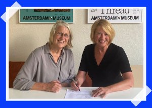 Foto met Judith van Gent, hoofd Collecties van Amsterdam Museum, en algemeen directeur Judikje Kiers die het manifest van het Netwerk Digitaal Erfgoed ondertekent